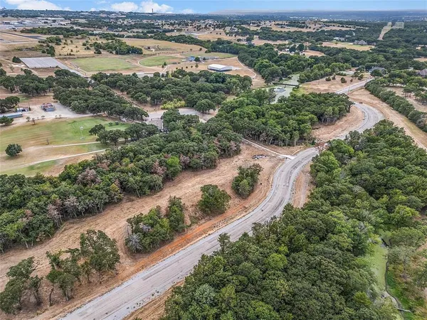 an aerial view of residential houses with outdoor space and river