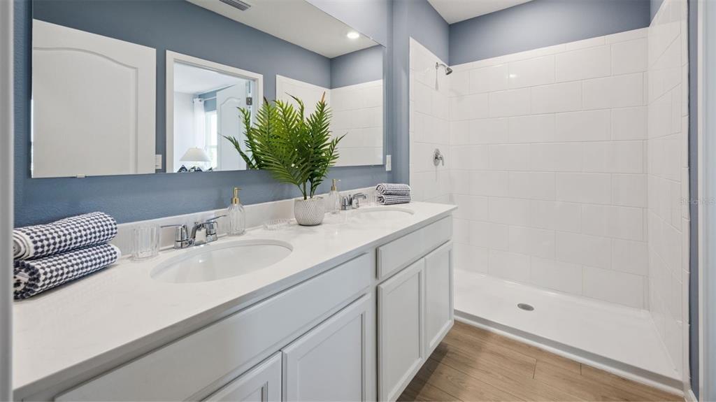 1022 Commons Way Port Port Orange, FL 32129 - Photo 14 of 17 a bathroom with a sink and a mirror