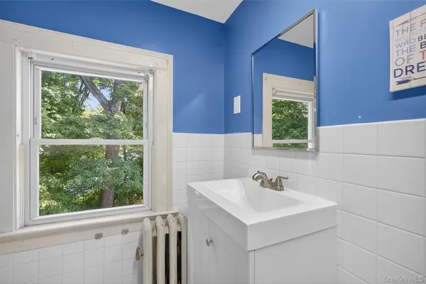 a bathroom with a sink and a window