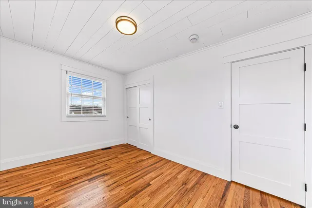 a view of a room with wooden floor