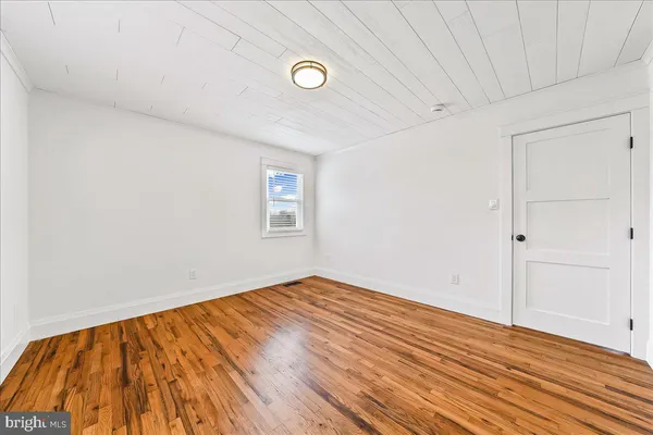 a view of a room with wooden floor and window