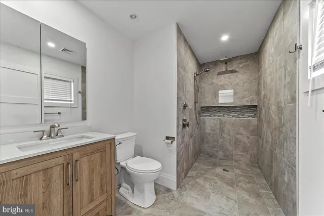 a bathroom with a sink toilet tub and shower