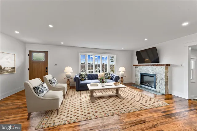 a living room with furniture a fireplace and a flat screen tv