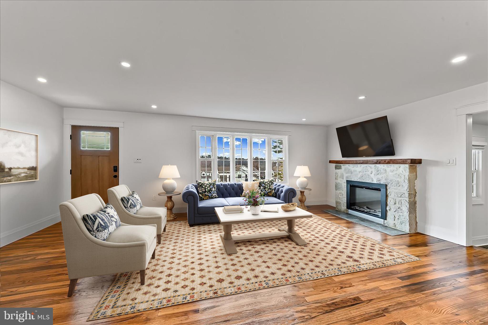 919 South Concord Road West Chester, PA 19382 - Photo 3 of 31 a living room with furniture a fireplace and a flat screen tv