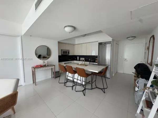 a living room with furniture and a mirror