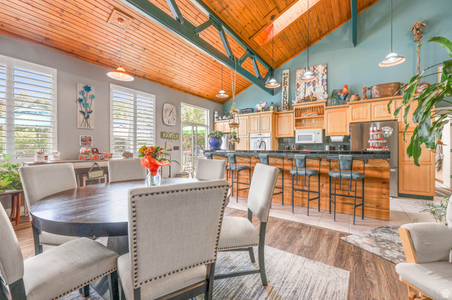 569 Elk Meadow Loop Tooele, UT 84074 - Photo 21 of 56 Dining area featuring a vaulted wood ceiling, light wood-style flooring, and a skylight