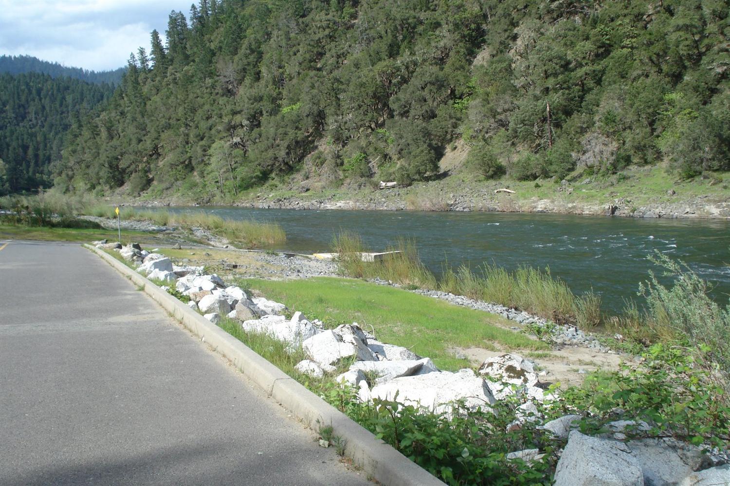 11800 Galice Road Merlin, OR 97532 - Photo 22 of 22 a view of a lake with a yard and a large tree