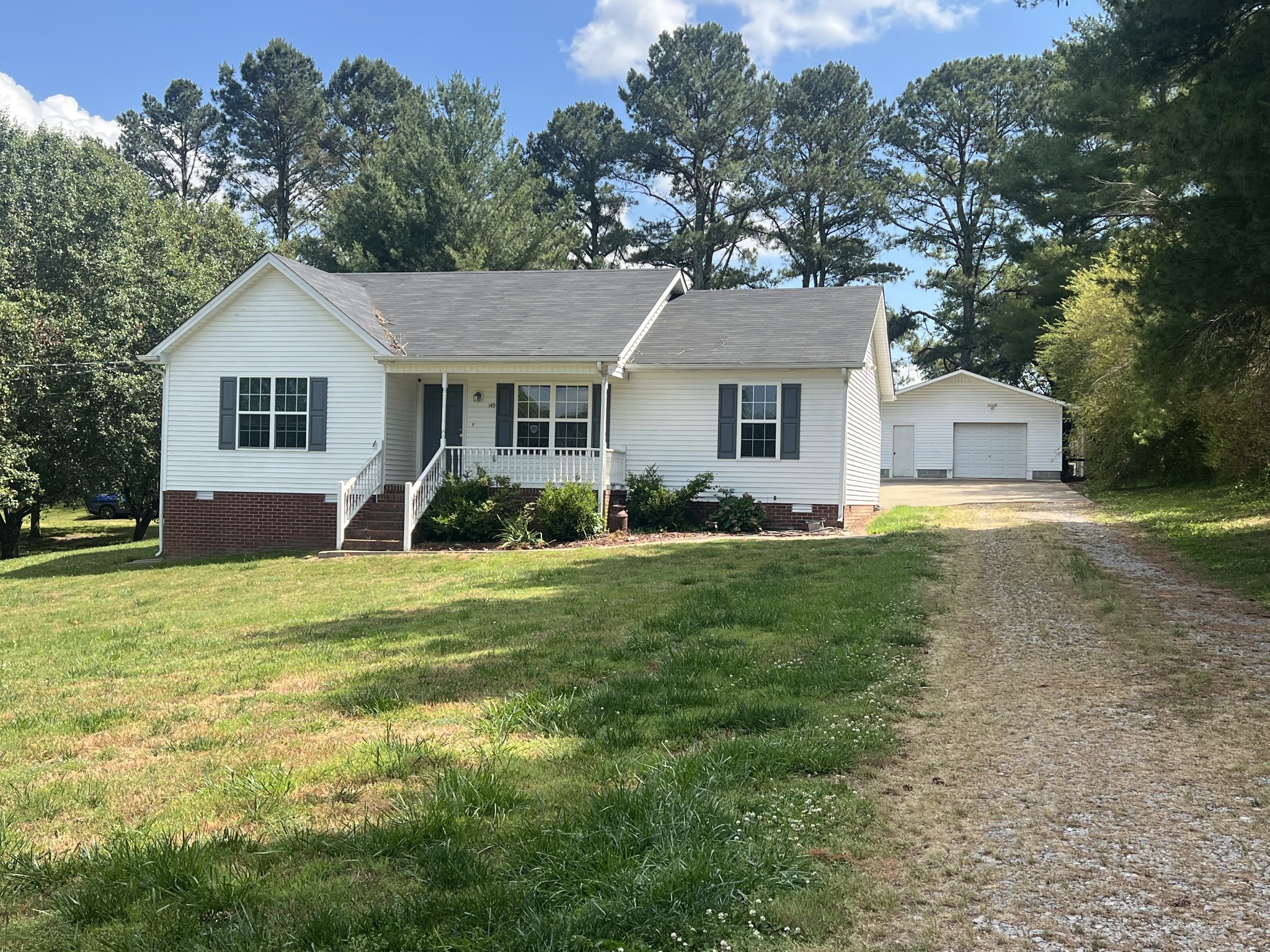 149 Hawthorne Street Pulaski, TN 38478 - Photo 1 of 33 a view of a house with a big yard and potted plants and large tree