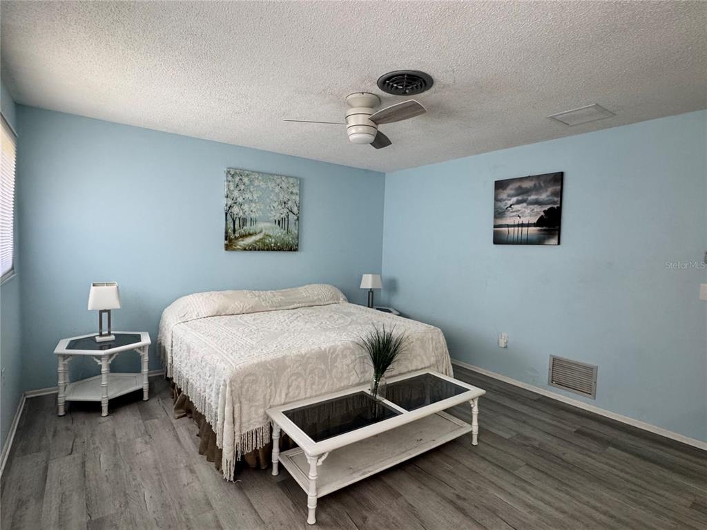 1048 Porpoise Road Venice, FL 34293 - Photo 16 of 26 a bedroom with a bed and wooden floor