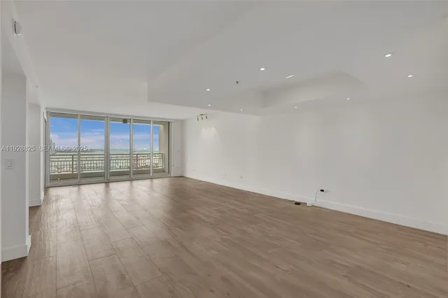 a kitchen with stainless steel appliances granite countertop a sink and a refrigerator