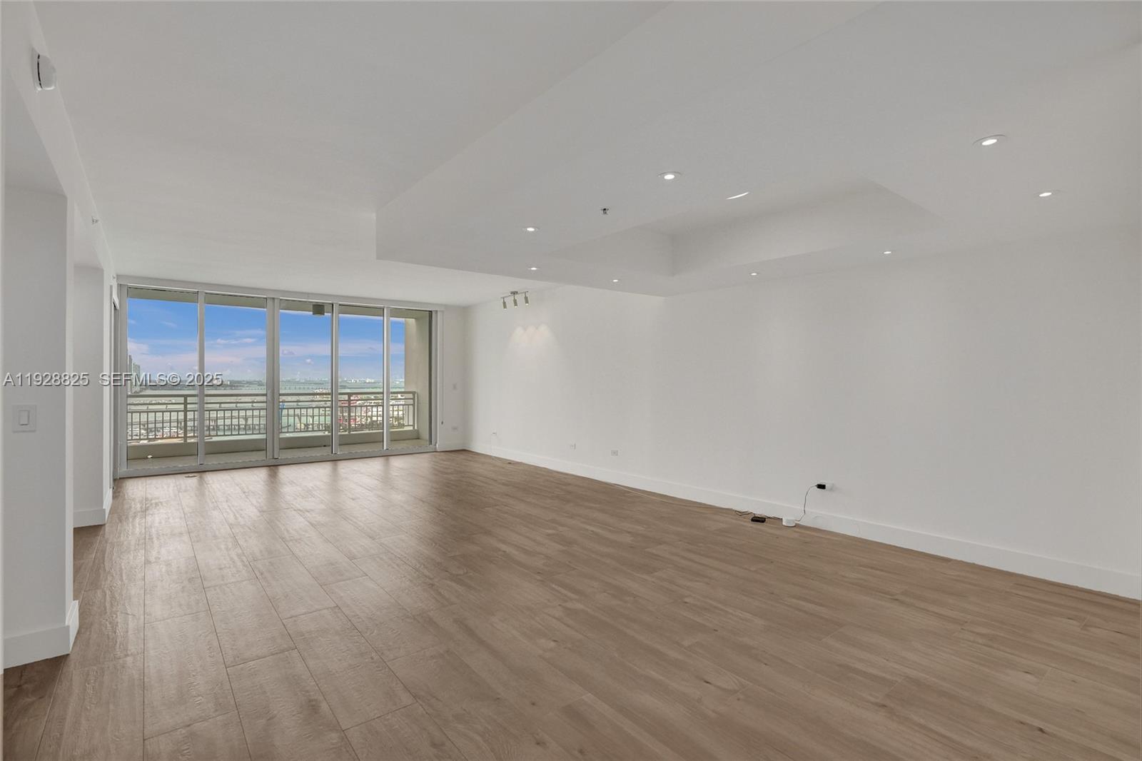848 Brickell Key Drive, Unit 3206 Miami, FL 33131 - Photo 11 of 93 a view of empty room with wooden floor and fan