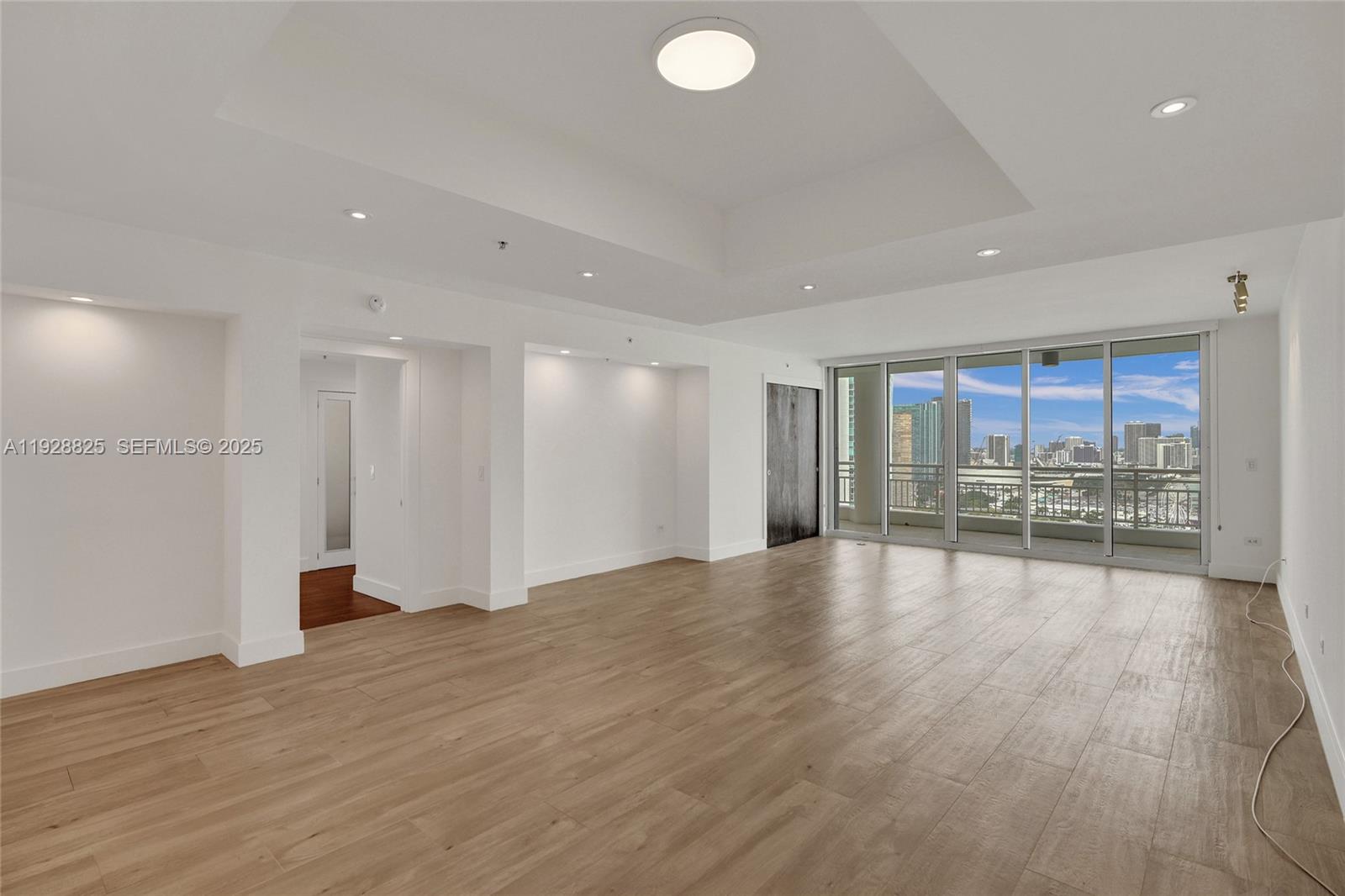 848 Brickell Key Drive, Unit 3206 Miami, FL 33131 - Photo 12 of 93 a view of an empty room with wooden floor and a window