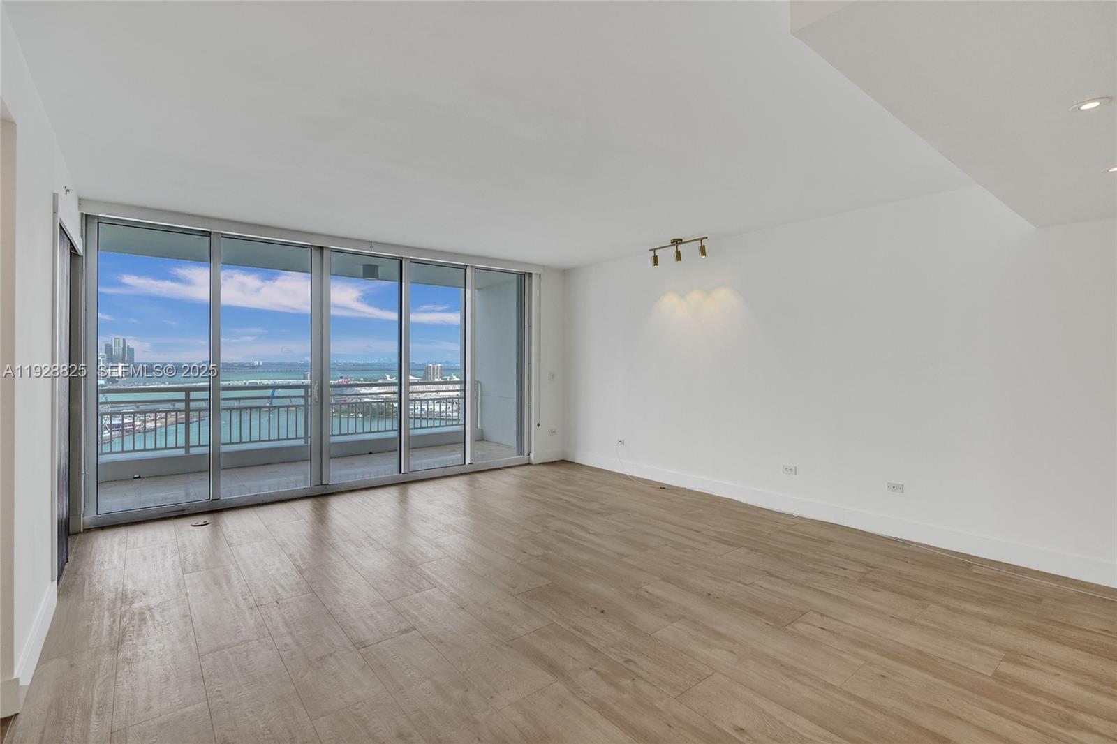848 Brickell Key Drive, Unit 3206 Miami, FL 33131 - Photo 13 of 93 wooden floor in an empty room with a window