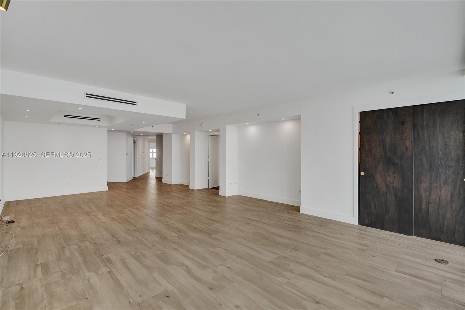 848 Brickell Key Drive, Unit 3206 Miami, FL 33131 - Photo 15 of 93 a view of an empty room with wooden floor and a window