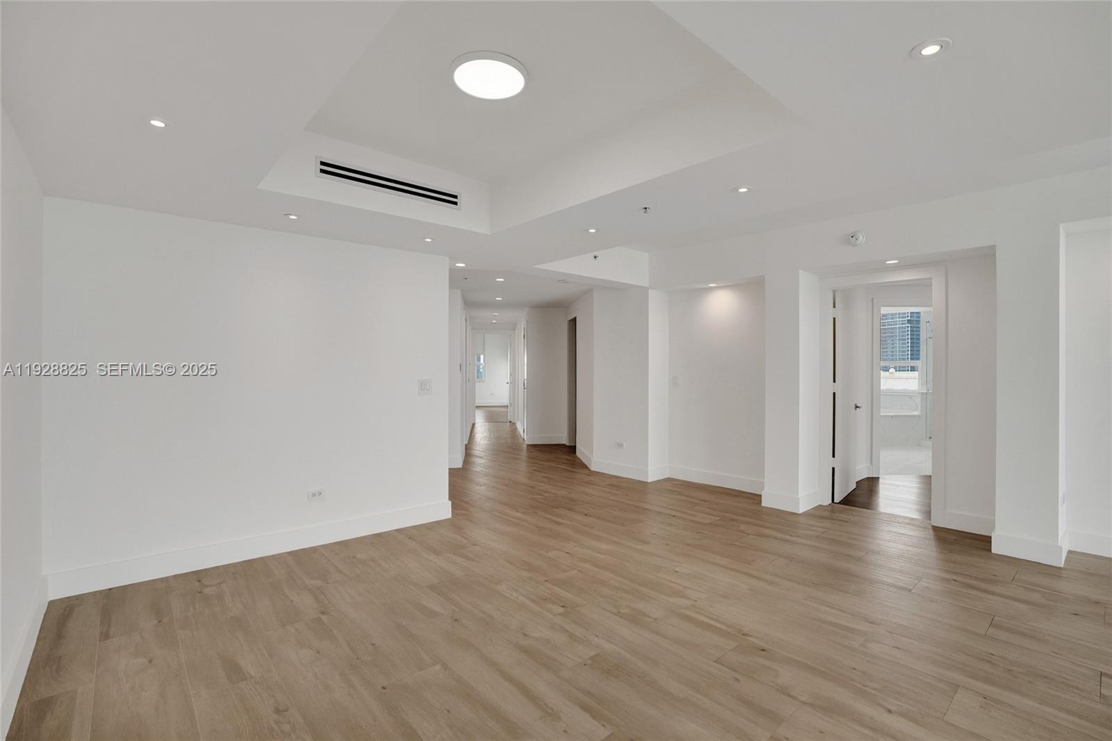 848 Brickell Key Drive, Unit 3206 Miami, FL 33131 - Photo 18 of 93 a view of an empty room with wooden floor and a window