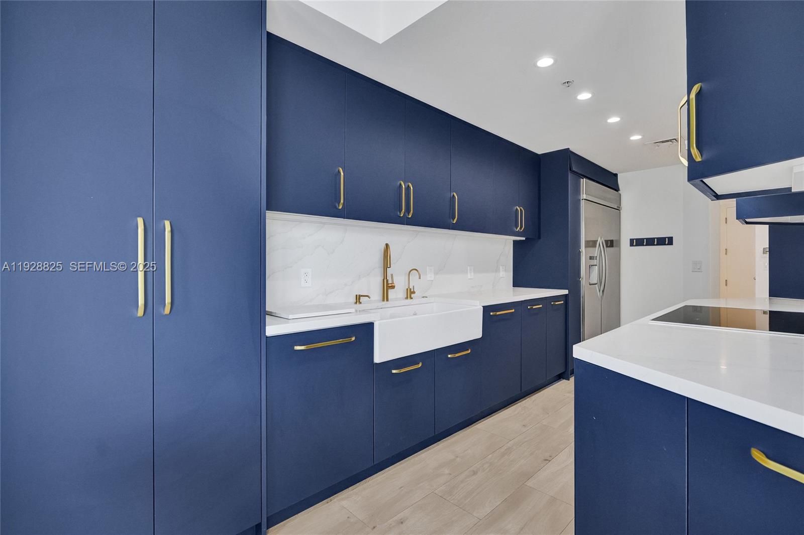 848 Brickell Key Drive, Unit 3206 Miami, FL 33131 - Photo 25 of 93 a kitchen with kitchen island a sink stainless steel appliances and cabinets