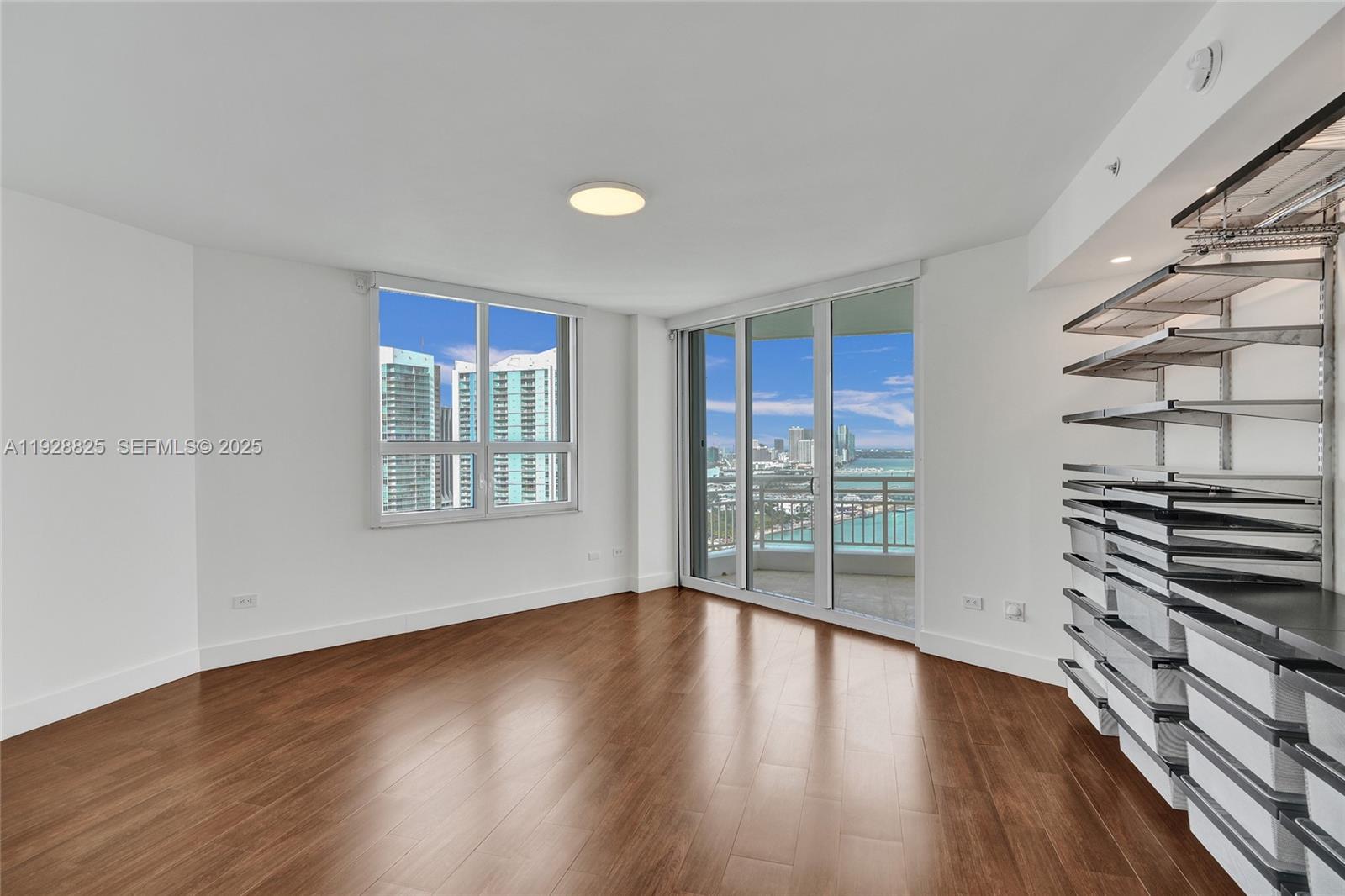 848 Brickell Key Drive, Unit 3206 Miami, FL 33131 - Photo 28 of 93 a view of wooden floor and windows in a room
