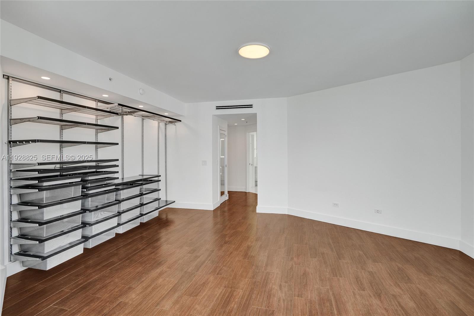 848 Brickell Key Drive, Unit 3206 Miami, FL 33131 - Photo 29 of 93 a view of an empty room with wooden floor and windows