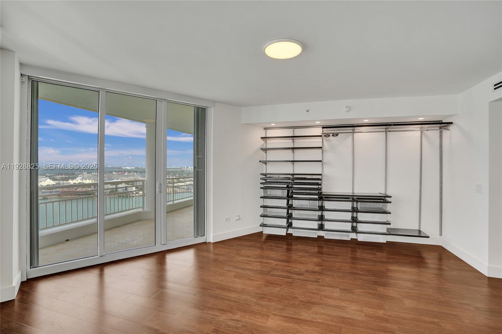 848 Brickell Key Drive, Unit 3206 Miami, FL 33131 - Photo 30 of 93 wooden floor in an empty room with a window
