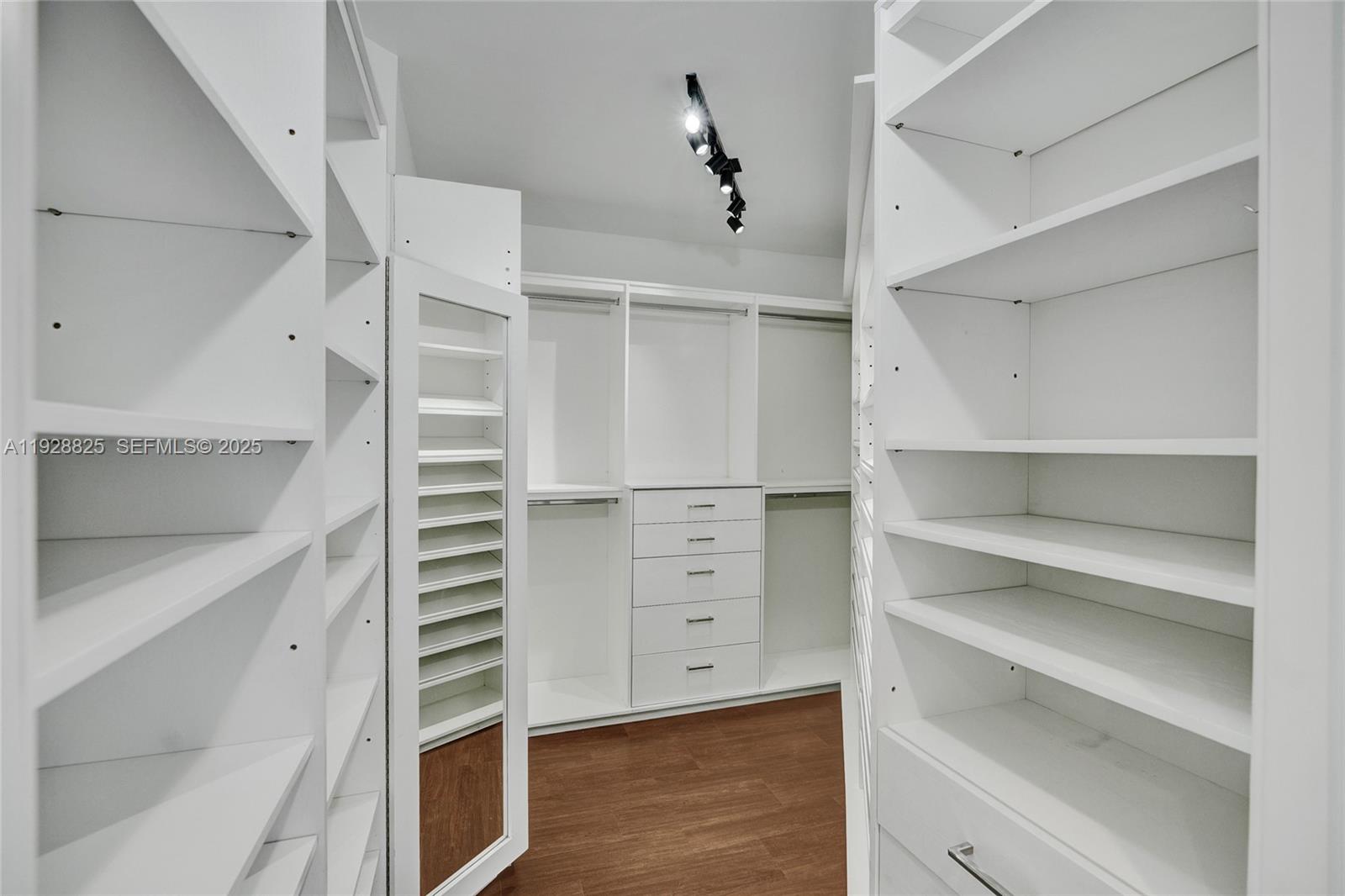 848 Brickell Key Drive, Unit 3206 Miami, FL 33131 - Photo 32 of 93 a view of walk in closet with empty racks