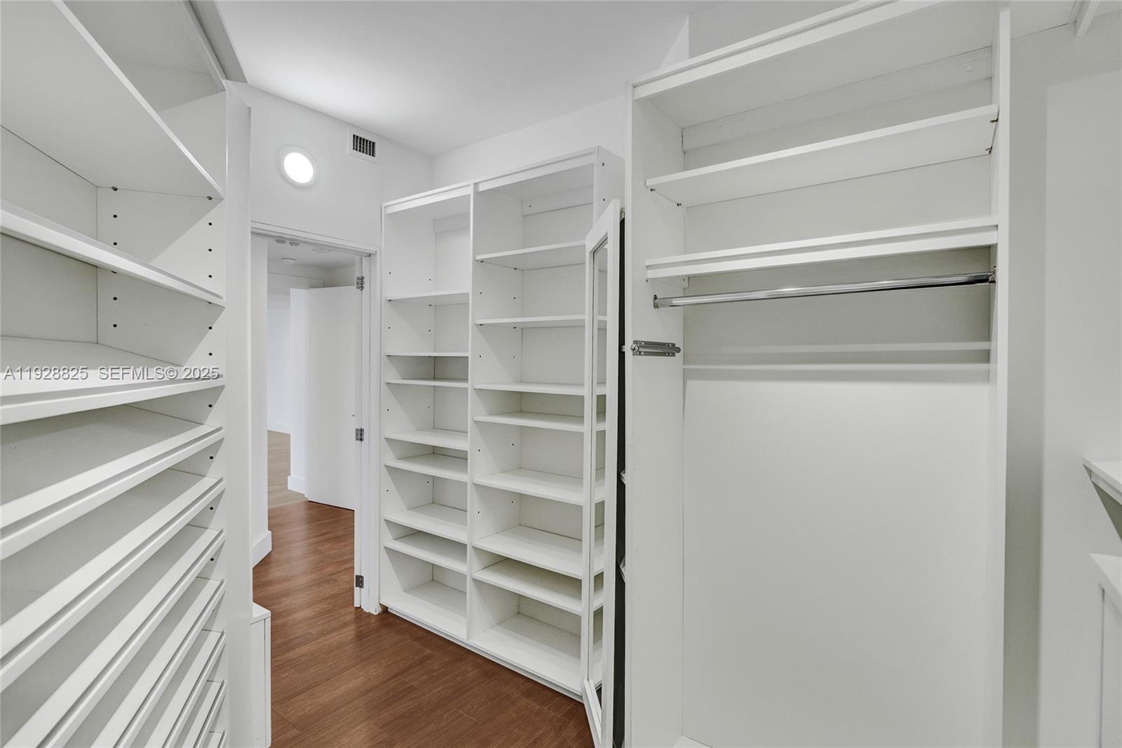 848 Brickell Key Drive, Unit 3206 Miami, FL 33131 - Photo 33 of 93 a view of walk in closet with empty racks