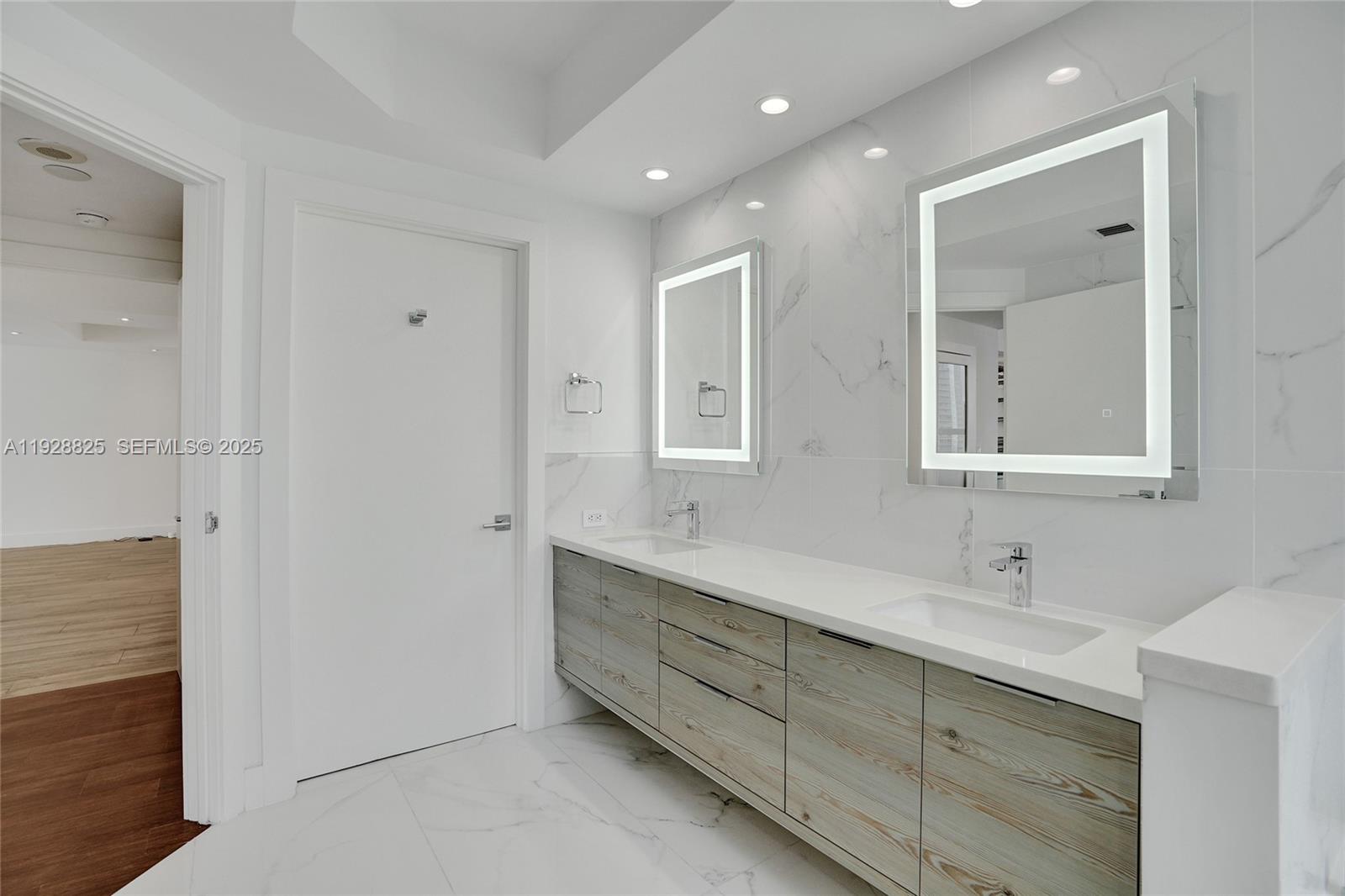 848 Brickell Key Drive, Unit 3206 Miami, FL 33131 - Photo 37 of 93 a bathroom with double vanity sinks and a mirror