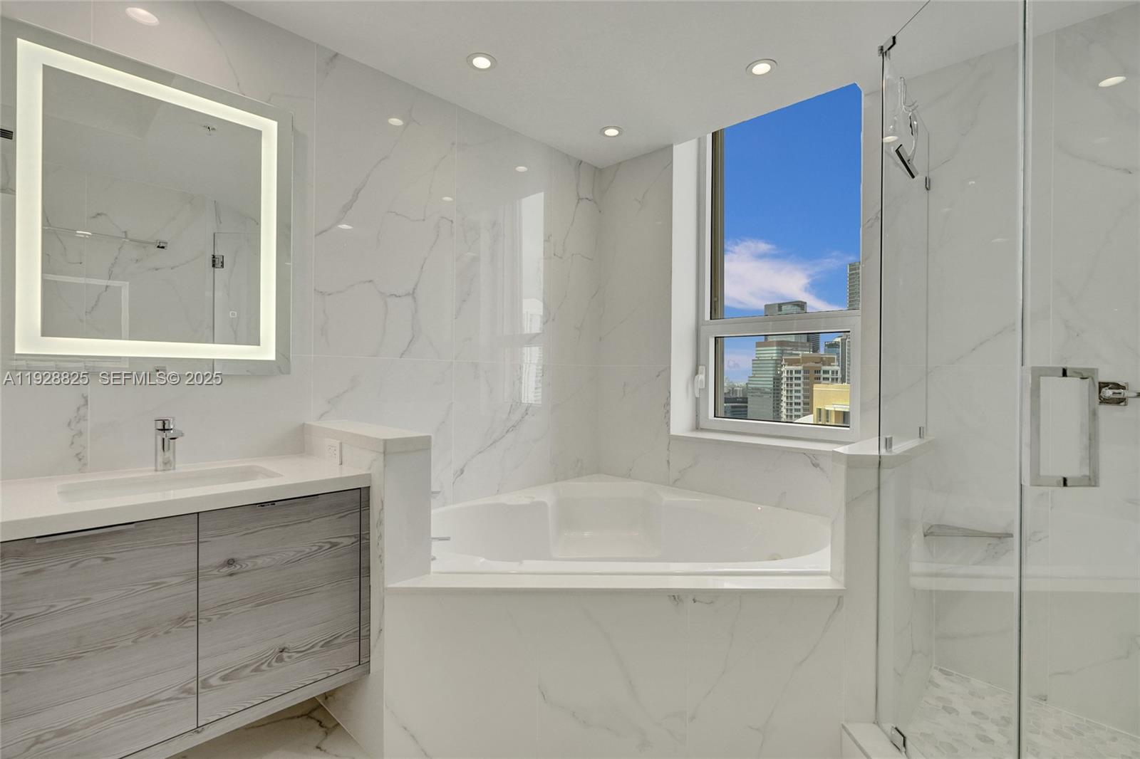 848 Brickell Key Drive, Unit 3206 Miami, FL 33131 - Photo 38 of 93 a bathroom with a bathtub and a sink