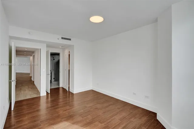 a view of a living room and kitchen with stainless steel appliances granite countertop a couch and a living room view