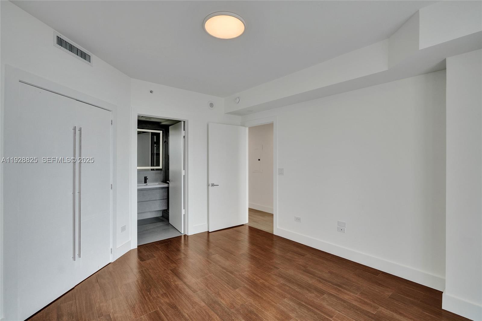 848 Brickell Key Drive, Unit 3206 Miami, FL 33131 - Photo 47 of 93 a view of an empty room with wooden floor and closet