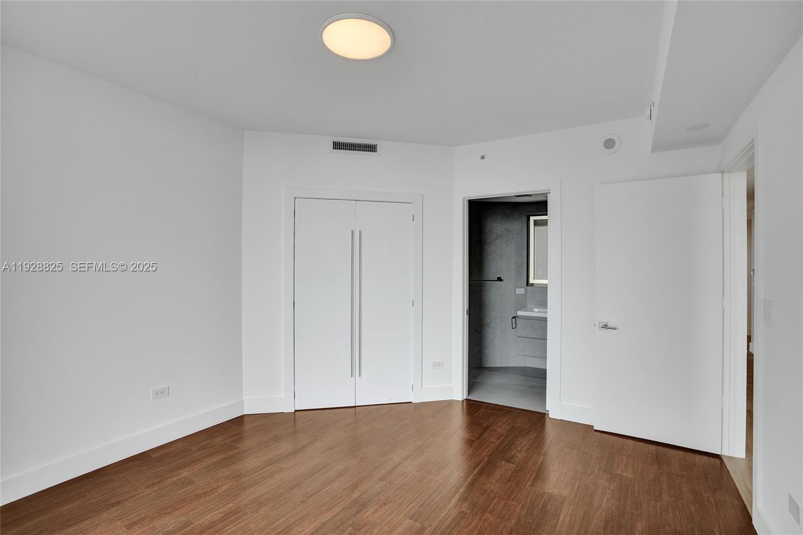 848 Brickell Key Drive, Unit 3206 Miami, FL 33131 - Photo 48 of 93 a view of an empty room with wooden floor