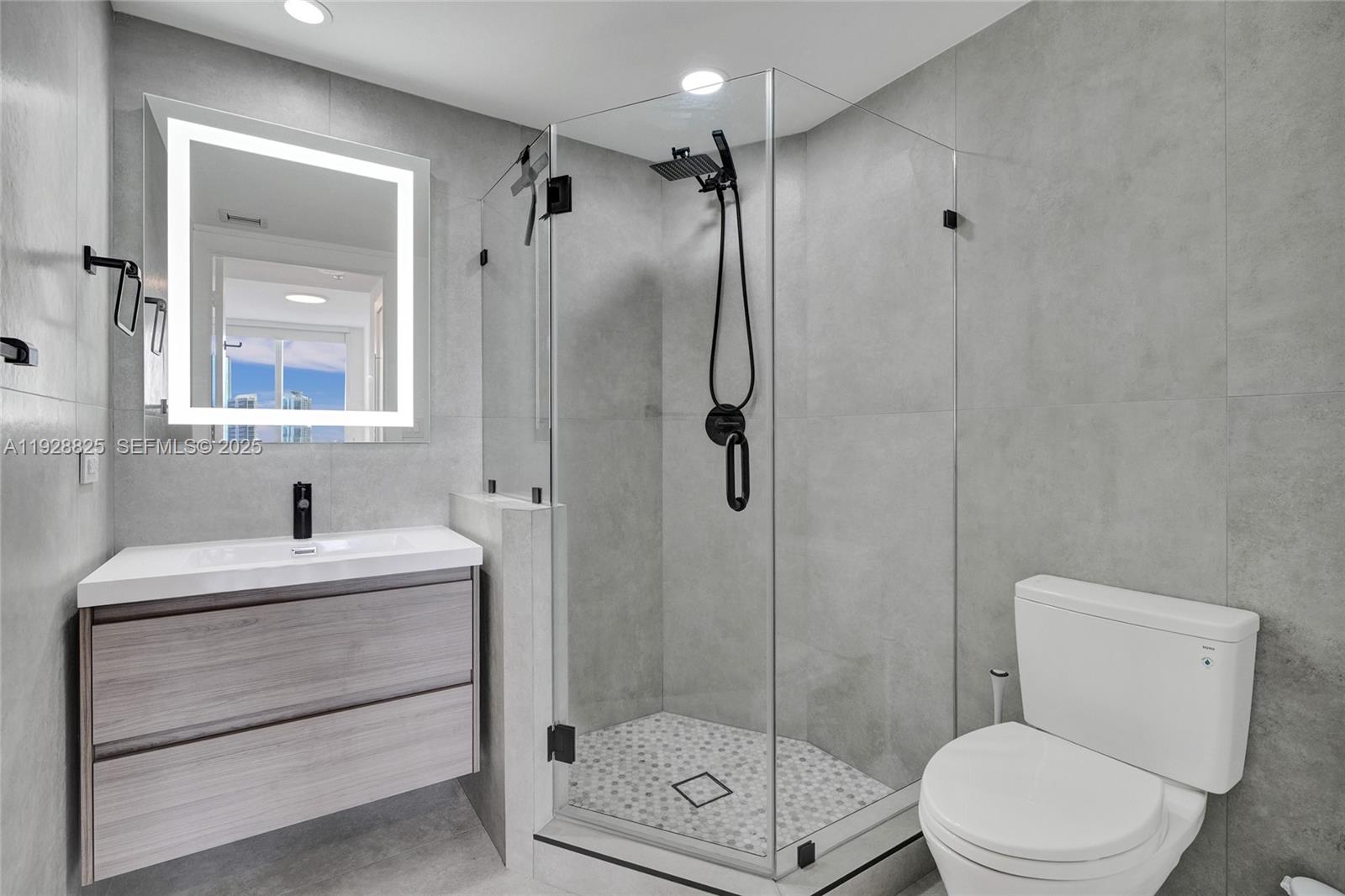 848 Brickell Key Drive, Unit 3206 Miami, FL 33131 - Photo 49 of 93 a bathroom with a sink toilet and shower