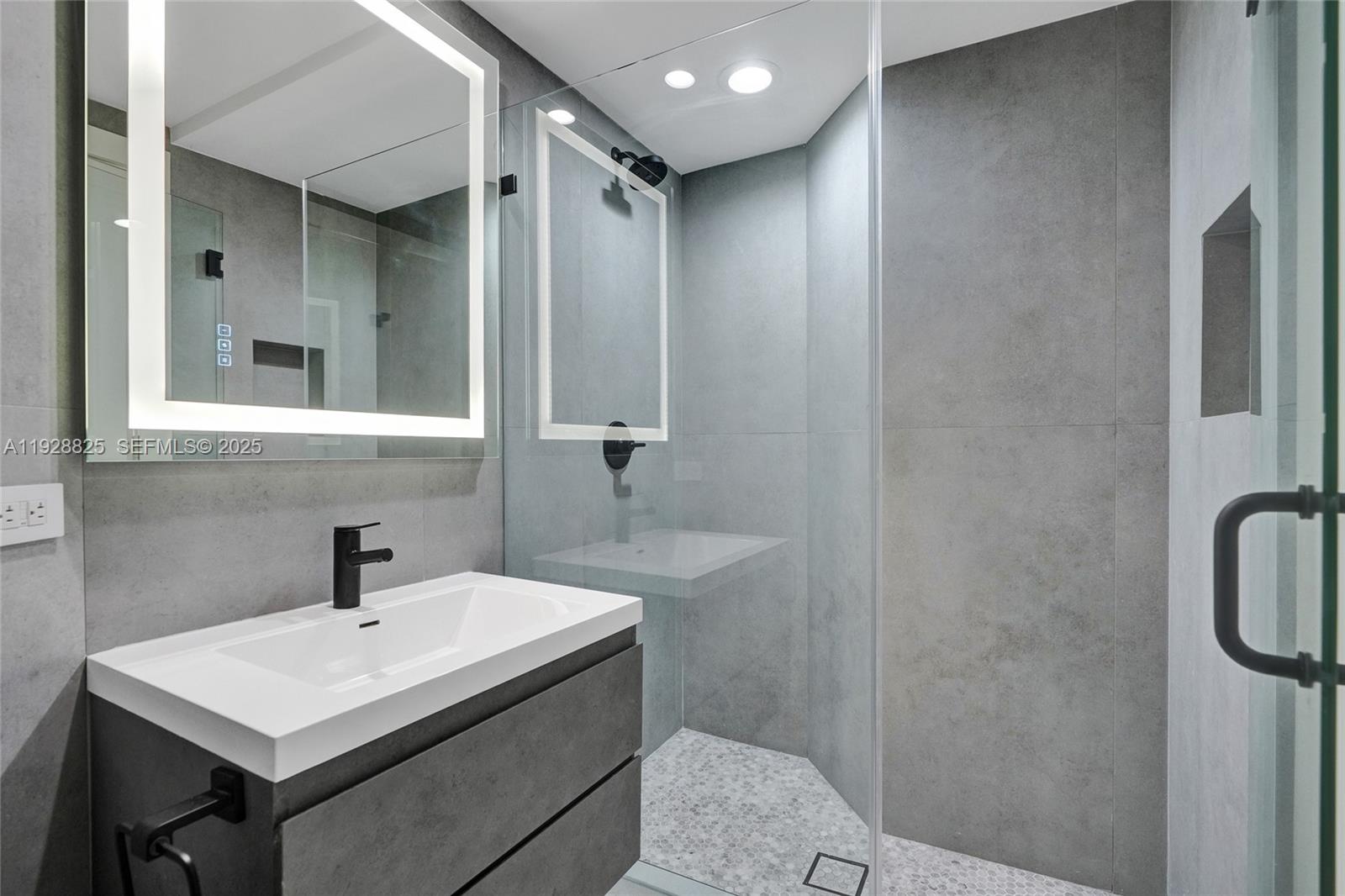 848 Brickell Key Drive, Unit 3206 Miami, FL 33131 - Photo 51 of 93 a bathroom with a sink a toilet and shower