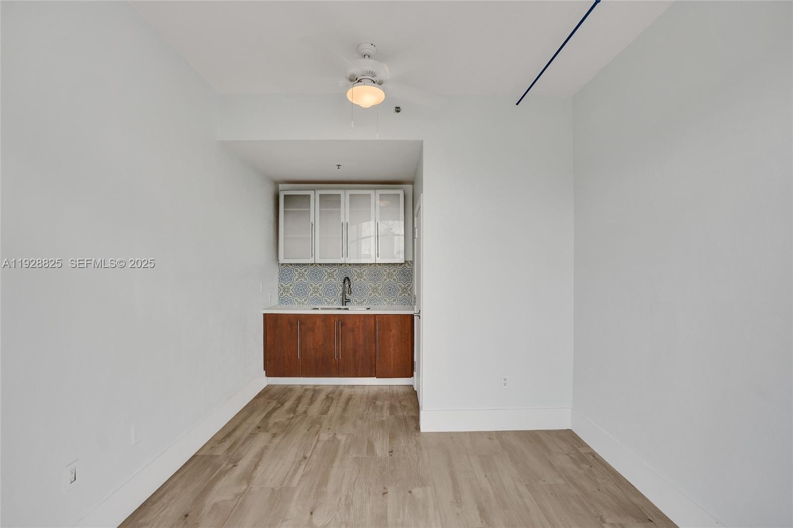 848 Brickell Key Drive, Unit 3206 Miami, FL 33131 - Photo 54 of 93 a room with wooden floor and window