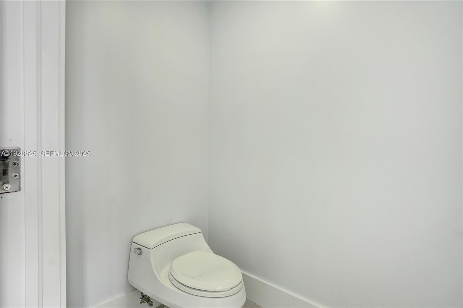 848 Brickell Key Drive, Unit 3206 Miami, FL 33131 - Photo 56 of 93 a white toilet sitting next to a white wall