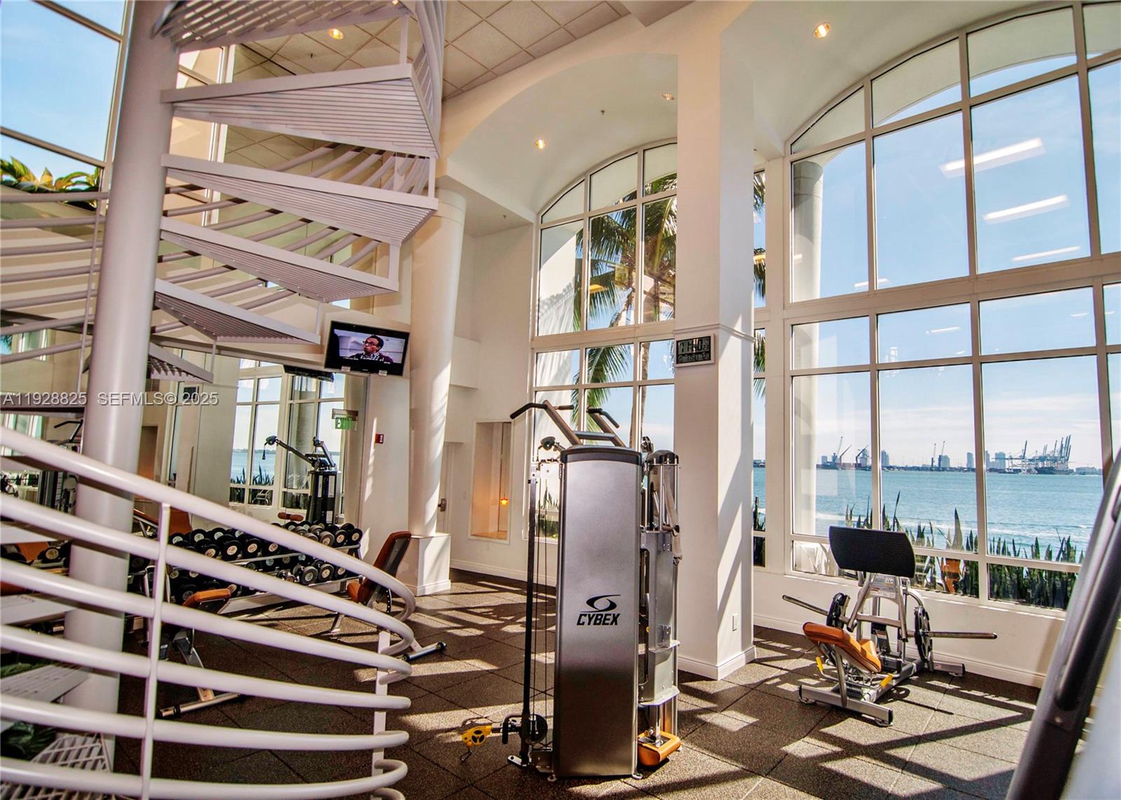 848 Brickell Key Drive, Unit 3206 Miami, FL 33131 - Photo 73 of 93 a view of gym equipment with large windows
