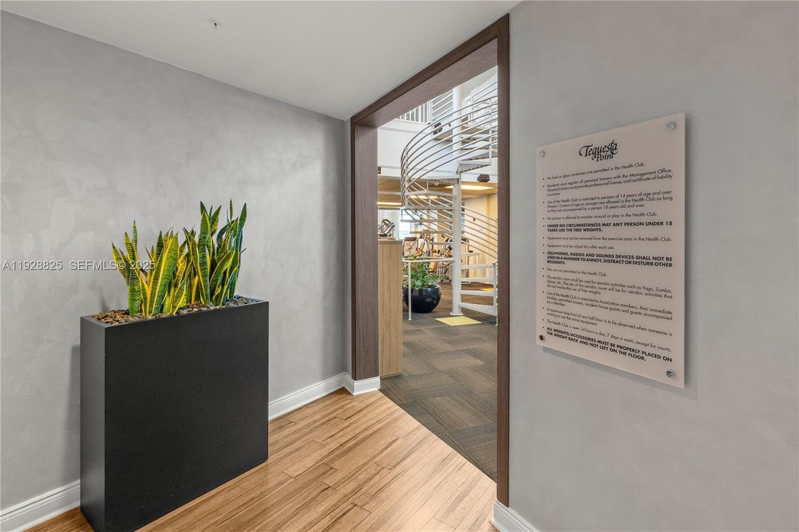 848 Brickell Key Drive, Unit 3206 Miami, FL 33131 - Photo 74 of 93 a view of a hallway with wooden floor and a bedroom