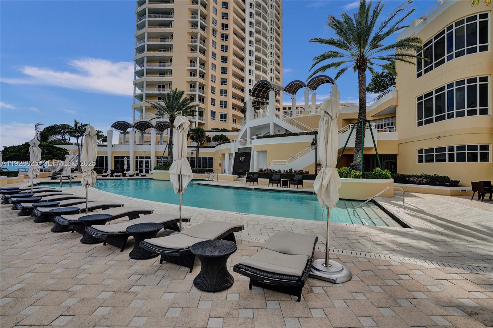 848 Brickell Key Drive, Unit 3206 Miami, FL 33131 - Photo 83 of 93 a view of a patio with couches and a fire pit