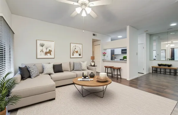 a living room with furniture and wooden floor