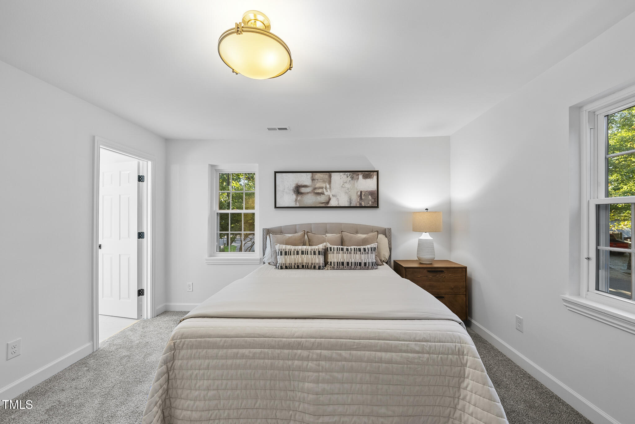2115 Port Royal Road Raleigh, NC 27609 - Photo 31 of 50 a bed room with a bed mirror and a window