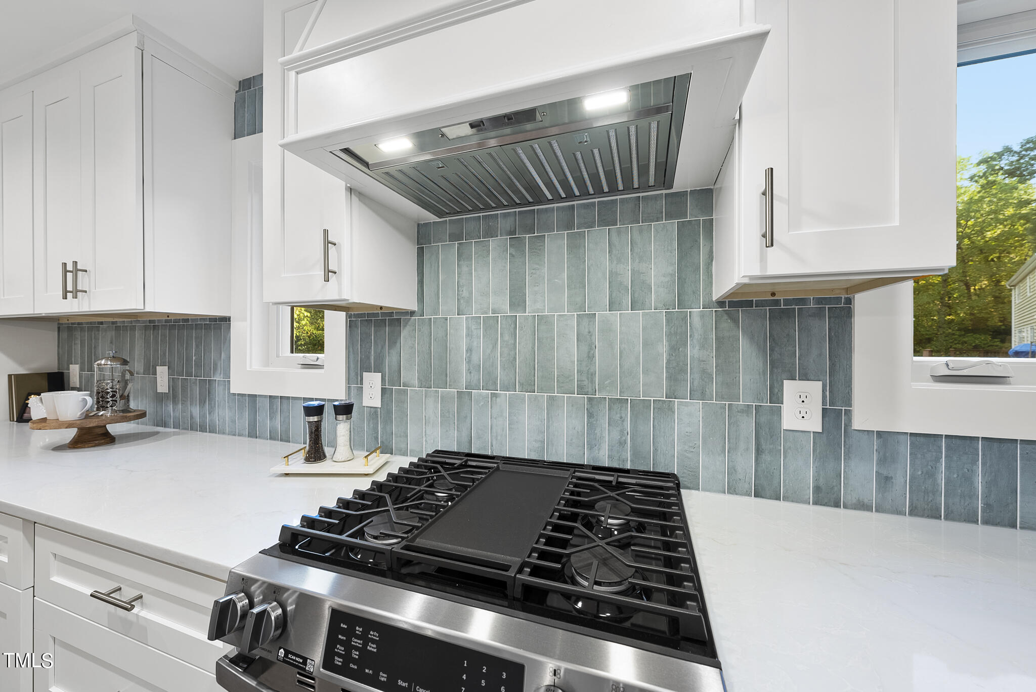 2115 Port Royal Road Raleigh, NC 27609 - Photo 9 of 50 a kitchen with granite countertop a stove and a sink