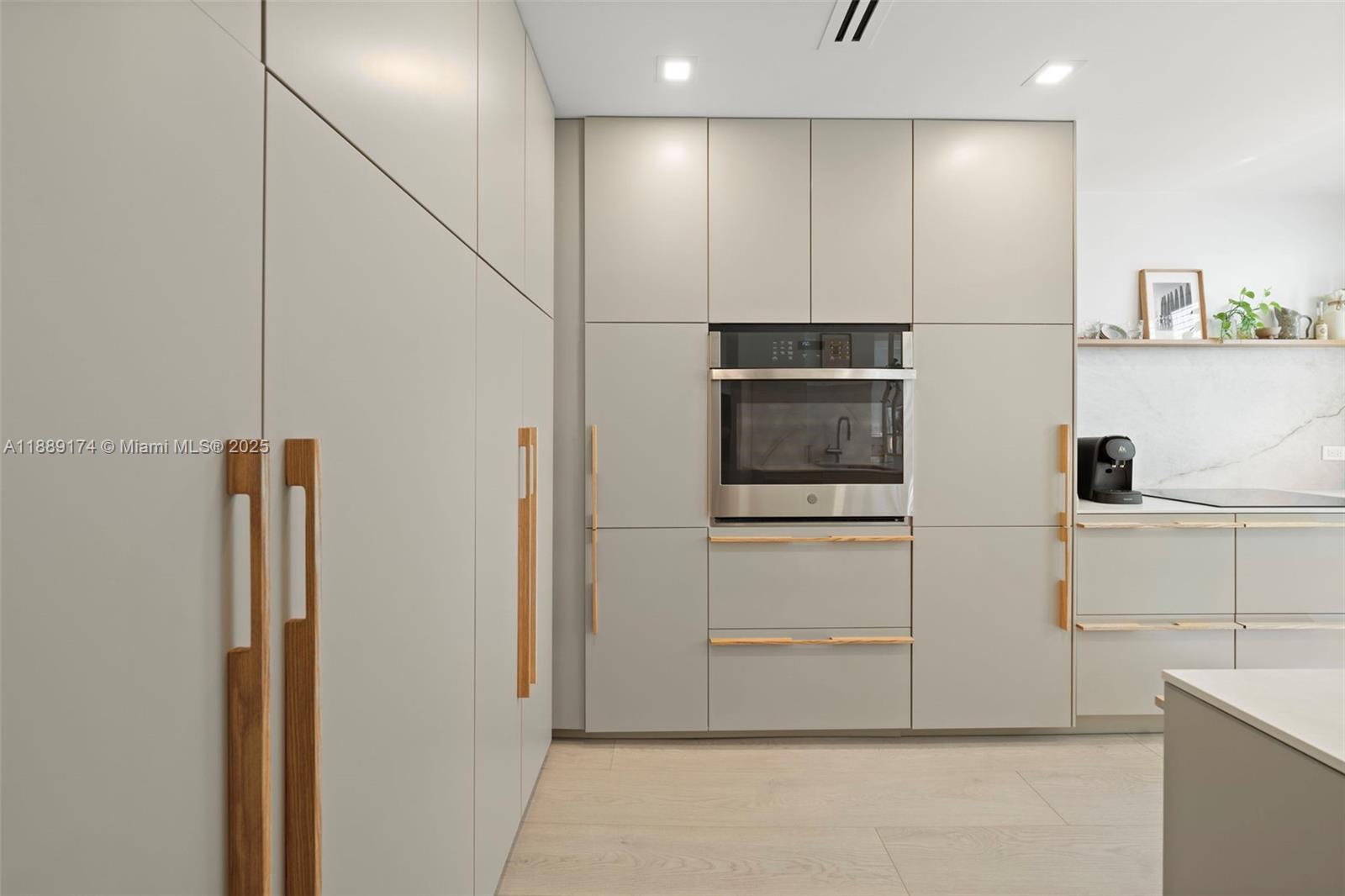 1390 Ocean Drive, Unit 202 Miami Beach, FL 33139 - Photo 12 of 80 a kitchen with stainless steel appliances a refrigerator and cabinets