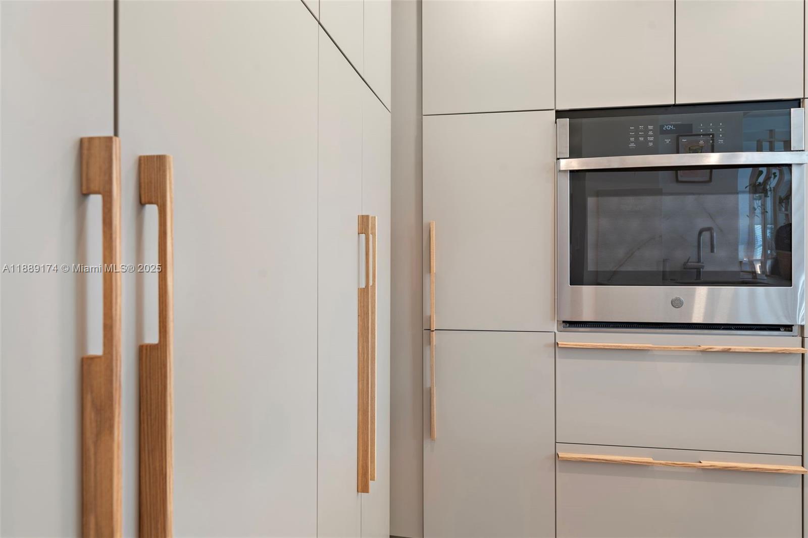 1390 Ocean Drive, Unit 202 Miami Beach, FL 33139 - Photo 15 of 80 a kitchen with a refrigerator and cabinets