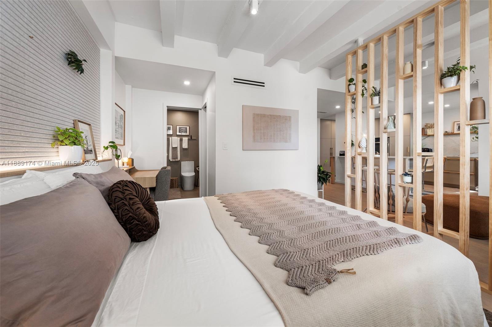 1390 Ocean Drive, Unit 202 Miami Beach, FL 33139 - Photo 29 of 80 a bedroom with a bed lamp and a large window