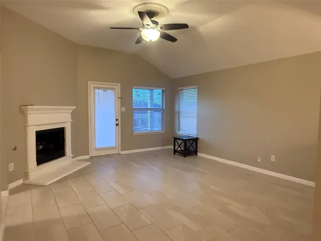 a view of an empty room with a fireplace