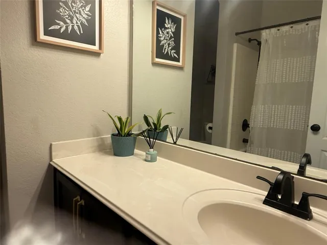 a bathroom with a sink a vanity and a mirror