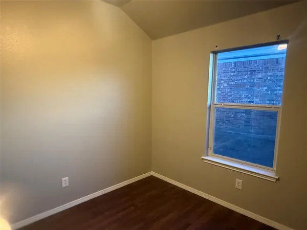 a view of a small space with a wooden door and a window