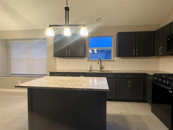 a kitchen with a sink and a stove
