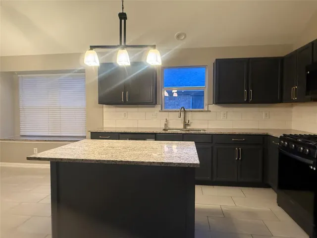 a kitchen with a sink and a stove