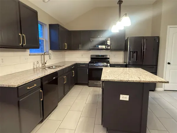 a kitchen with a sink a stove and refrigerator