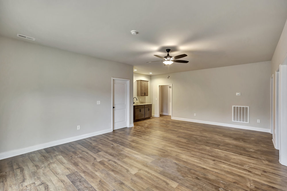 118 Bonaire Point Anderson, SC 29621 - Photo 10 of 23 This versatile open-concept space features warm wood-style flooring and a convenient wet bar, ideal for entertaining.